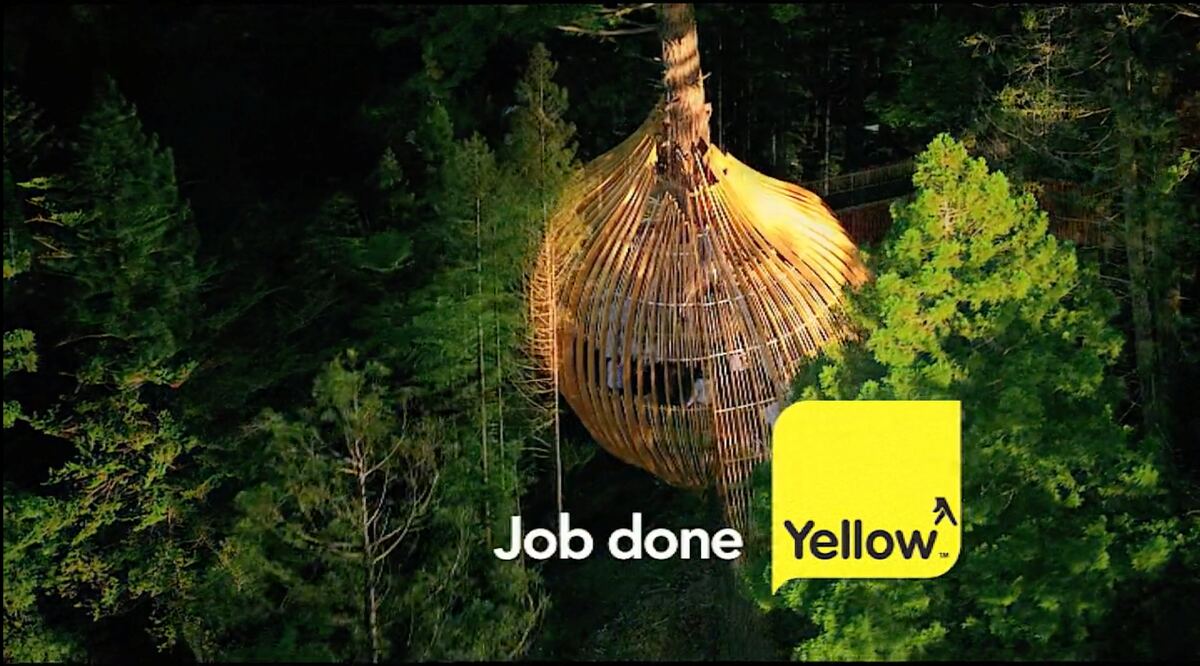 The Yellow Pages treehouse restaurant lit at dusk
